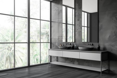 Photo for Stylish hotel bathroom interior with double sink and vanity, side view black hardwood floor. Two washbasins and tall mirror on tile wall, panoramic window on tropics. 3D rendering - Royalty Free Image
