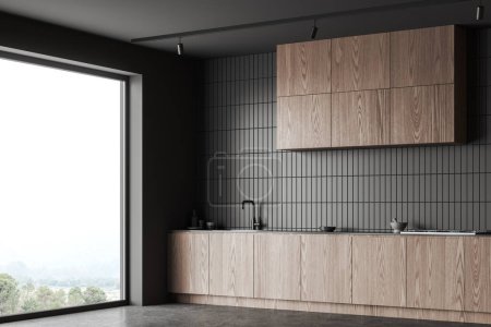 Photo for Grey tile and wooden home kitchen interior with cabinet and kitchenware, side view grey concrete floor. Dark cooking space in modern apartment with panoramic window. 3D rendering - Royalty Free Image