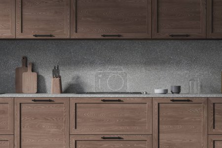 Téléchargez les photos : Intérieur d'une cuisine élégante avec des murs gris clair et des placards en bois foncé confortables et des armoires avec cuisinière intégrée. Rendu 3d - en image libre de droit