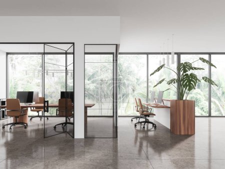 Photo for Stylish office interior with reception desk and glass room, pc computers on shared table. Coworking space with panoramic window on tropics. 3D rendering - Royalty Free Image