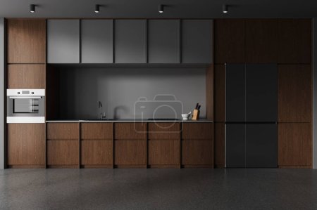 Téléchargez les photos : Intérieur de la cuisine moderne avec murs gris, sol en béton, placards gris confortables, armoires en bois sombre avec cuisinière intégrée, évier et four et grand réfrigérateur. Rendu 3d - en image libre de droit