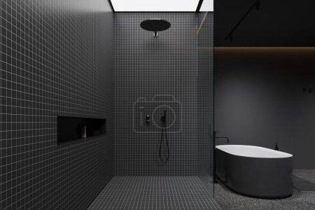 Téléchargez les photos : Intérieur de la salle de bain élégante avec des murs de carrelage gris et gris foncé, sol en béton, baignoire grise confortable et confortable douche à l'italienne avec mur de verre. Rendu 3d - en image libre de droit