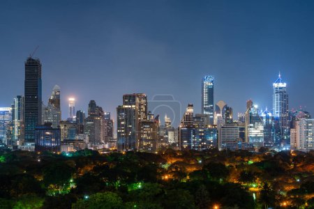 Photo for View of night Bangkok city panorama with glowing skyscrapers windows and trees. Concept of tourism and travel in Thailand - Royalty Free Image