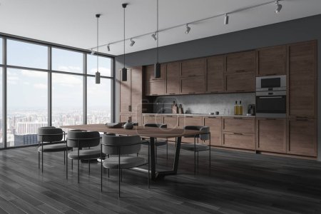 Photo for Corner of stylish kitchen with gray walls, wooden floor, comfortable dark wooden cupboards and cabinets and long dining table with gray chairs standing near panoramic window. 3d rendering - Royalty Free Image