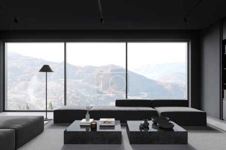 Foto de Interior de la elegante sala de estar con paredes grises, suelo de hormigón, dos cómodos sofás grises de pie cerca de la ventana panorámica con vista a la montaña y mesas de café cuadradas. renderizado 3d - Imagen libre de derechos