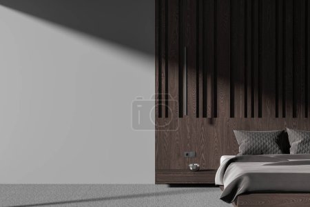 Téléchargez les photos : Intérieur sombre de la chambre à coucher avec lit et table de chevet, tapis gris sur le sol. Détendez-vous ou dormez avec la décoration et les panneaux en bois marron, maquillez le mur vide d'espace de copie. rendu 3D - en image libre de droit
