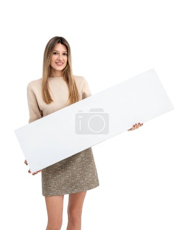 Photo for Happy smiling woman holding a mockup blank sign banner in hands, isolated over white background. Concept of sale, advertisement, offer and recommendation - Royalty Free Image
