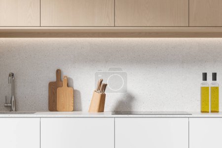 Téléchargez les photos : Intérieur de la cuisine moderne avec murs blancs, placards en bois et élégant évier et cuisinière construit dans des armoires blanches confortables. Rendu 3d - en image libre de droit