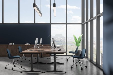 Photo for Blue coworking interior with pc computers on desk, blue chairs in row on grey concrete floor. Minimalist workplace with sideboard and panoramic window on New York. 3D rendering - Royalty Free Image