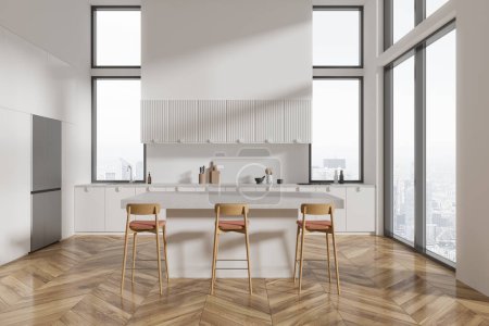 Photo for White home kitchen interior with bar island and stool, hardwood floor. Elegant cooking space with fridge and cabinet with kitchenware. Panoramic window on Paris skyscrapers. 3D rendering - Royalty Free Image