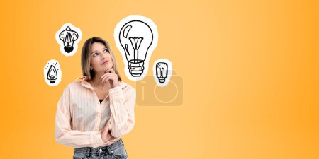 Photo for Dreaming and thinking young woman portrait looking up, light bulbs doodle drawing on orange empty copy space background. Concept of brainstorm, creativity and new idea - Royalty Free Image