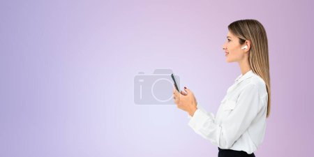 Photo for Young smiling woman profile using smartphone and earbuds, listen and texting on copy space empty wall purple background. Concept of online conference, communication and device - Royalty Free Image