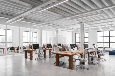 Photo for Corner of modern open space office with white and glass walls, concrete floor, massive wooden computer tables and conference room in background. 3d rendering - Royalty Free Image
