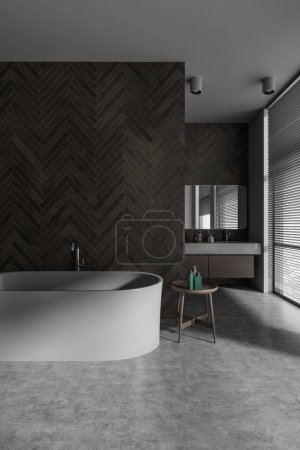 Photo for Interior of modern bathroom with gray and dark stone walls, concrete floor, comfortable gray bathtub and cozy sink with mirror in background. 3d rendering - Royalty Free Image