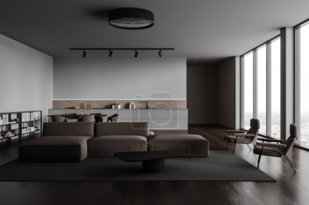 Foto de Interior de la moderna sala de estar con paredes grises, suelo de madera, acogedor sofá marrón y sillones de pie cerca de la mesa de café y cocina con armarios y mesa de comedor en el fondo. renderizado 3d - Imagen libre de derechos