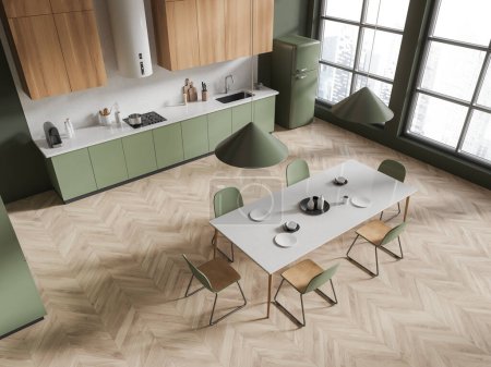 Photo for Top view of home kitchen interior with eating table and chairs, hardwood floor. Green and wooden cooking corner with cabinet and fridge. Panoramic window on skyscrapers. 3D rendering - Royalty Free Image