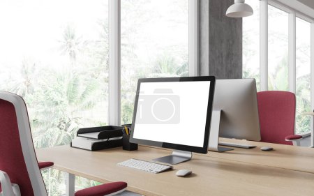 Foto de Elegante interior del lugar de trabajo con la pantalla en blanco del ordenador de la PC de la maqueta, esquina de coworking vista lateral con el sillón rojo y ventana panorámica en los trópicos. Renderizado 3D - Imagen libre de derechos