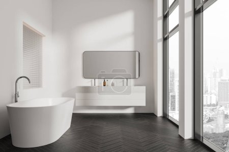 Téléchargez les photos : Intérieur de salle de bain moderne avec murs blancs, sol en bois, baignoire blanche confortable et double lavabo confortable avec grand miroir suspendu près de la grande fenêtre. Rendu 3d - en image libre de droit