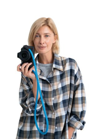 Photo for Isolated portrait of concentrated young woman wearing casual clothes and holding camera. White background. Concept of hobby and art - Royalty Free Image