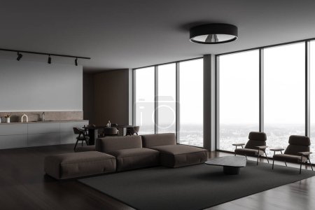 Foto de Esquina de la moderna sala de estar con paredes grises, suelo de madera, acogedor sofá marrón y sillones de pie cerca de la mesa de café y cocina con armarios y mesa de comedor en el fondo. renderizado 3d - Imagen libre de derechos