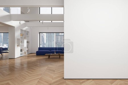 Foto de Interior de la moderna sala de estar con paredes blancas, suelo de madera, cómodo sofá azul de pie cerca de la mesa de centro de madera y librería blanca. Copia la pared del espacio a la izquierda. renderizado 3d - Imagen libre de derechos