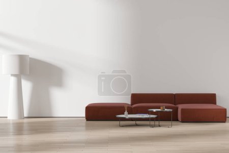 Foto de Interior de la moderna sala de estar minimalista con paredes blancas, suelo de madera, acogedor sofá marrón de pie cerca de mesas de café redondas y la pared del espacio de copia. renderizado 3d - Imagen libre de derechos