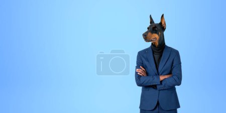 Photo for Portrait of confident businessman with dog head standing with crossed arms over blue copy space background. Concept of leadership - Royalty Free Image