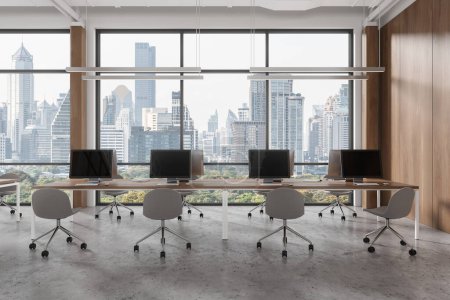 Téléchargez les photos : Élégant intérieur de coworking avec chaises et bureau pc en rangée, sol en béton gris. Bureau d'entreprise moderne avec fenêtre panoramique sur les gratte-ciel de Bangkok. rendu 3D - en image libre de droit
