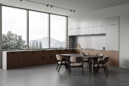 Photo for Corner of stylish kitchen with gray walls, concrete floor, comfortable wooden cabinets with built in cooker and sink and long dining table with beige chairs. 3d rendering - Royalty Free Image