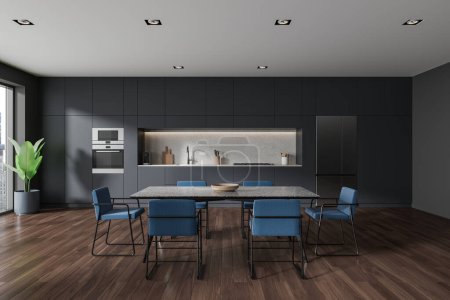 Photo for Dark home kitchen interior with eating table and blue chairs. Cooking cabinet with sink, oven and refrigerator on hardwood floor. Panoramic window on skyscrapers. 3D rendering - Royalty Free Image