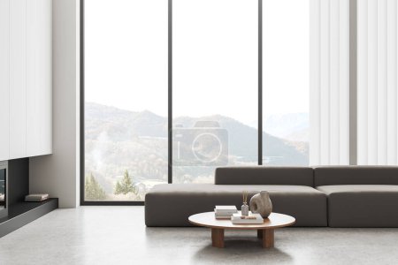 Photo for Interior of modern living room with white walls, concrete floor, comfortable gray couch standing near round coffee table and panoramic window with mountain view. 3d rendering - Royalty Free Image