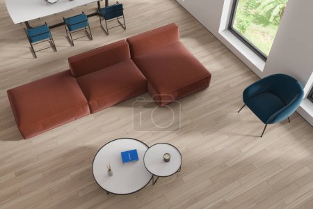 Photo for Top view of modern living room with white walls, wooden floor, comfortable brown couch standing near round coffee tables and dining room with long table and chairs next to it. 3d rendering - Royalty Free Image