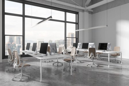Photo for Stylish office interior with pc computers and shared desk in row, side view grey concrete floor. Stylish coworking corner with panoramic window on Kuala Lumpur skyscrapers. 3D rendering - Royalty Free Image