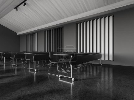 Téléchargez les photos : Intérieur de la salle de classe grise avec chaises et bureau sur roues en rangée, sol en béton noir. Vue en angle de l'espace d'apprentissage minimaliste avec des meubles minimalistes. rendu 3D - en image libre de droit