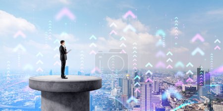 Photo for Side view of young businessman with documents standing in smart city and looking at arrows in the sky. Concept of internet of things and digital city technology - Royalty Free Image
