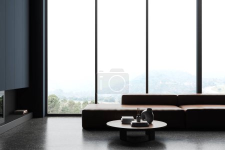Foto de Interior de la elegante sala de estar con paredes azules, suelo de hormigón, cómodo sofá de cuero de pie cerca de la mesa redonda y ventana panorámica con vista a la montaña. renderizado 3d - Imagen libre de derechos