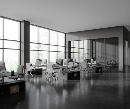 Foto de Esquina de elegante oficina de espacio abierto con paredes grises y de madera, piso de hormigón, filas de escritorios de ordenador con sillas grises y sala de reuniones de pared de vidrio en el fondo. renderizado 3d - Imagen libre de derechos
