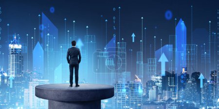 Photo for Businessman standing on a concrete plate, looking at skyline with city wireframe hologram, skyscrapers with matrix and arrows. Concept of futuristic technology and virtual reality - Royalty Free Image
