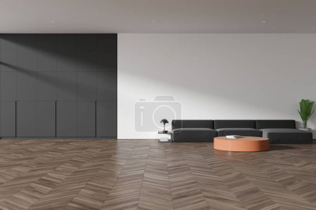 Foto de Interior de la moderna sala de estar con paredes blancas, suelo de madera, acogedor sofá gris de pie cerca de la mesa de centro redonda y gran armario gris. renderizado 3d - Imagen libre de derechos