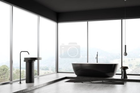 Téléchargez les photos : Intérieur sombre de la salle de bain de l'hôtel avec baignoire et lavabo avec robinet mélangeur monté, tapis sur sol en béton gris. Coin baignade dans un appartement minimaliste. Fenêtre panoramique sur campagne. rendu 3D - en image libre de droit