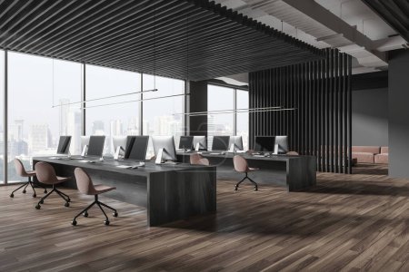Photo for Dark office interior with coworking room and pc computers, side view workspace with table and armchairs in row on hardwood floor. Panoramic window on Singapore skyscrapers. 3D rendering - Royalty Free Image