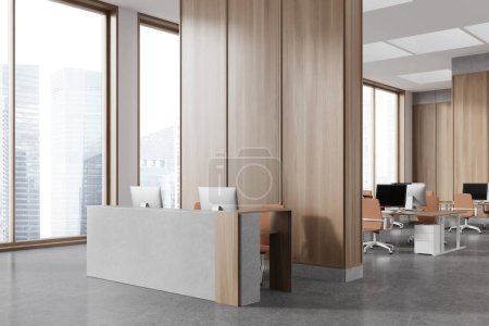 Foto de Esquina del moderno hall de oficinas con paredes blancas y de madera, suelo de hormigón y cómodo mostrador de recepción blanco y de madera con dos computadoras. renderizado 3d - Imagen libre de derechos