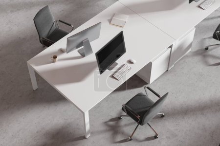 Foto de Vista superior del interior de coworking con ordenadores PC en el escritorio, sillones grises en el suelo de hormigón ligero. Moderno lugar de trabajo de oficina con muebles minimalistas para el trabajo en equipo. Renderizado 3D - Imagen libre de derechos