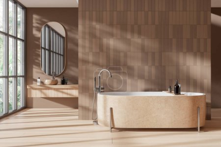 Téléchargez les photos : Élégant hôtel salle de bain intérieure avec baignoire en pierre beige et lavabo avec vanité, parquet. Bain ou spa dans un appartement de luxe avec espace de copie mur de tuiles vides. Fenêtre panoramique. rendu 3D - en image libre de droit