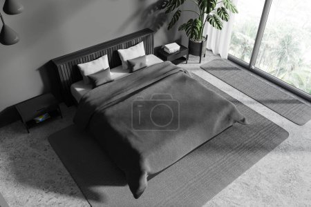 Photo for Top view of dark hotel bedroom interior with bed and carpet on concrete floor, nightstand with books and decoration. Relax corner with panoramic window on tropics. 3D rendering - Royalty Free Image