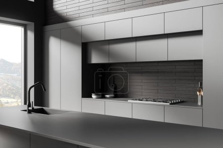 Téléchargez les photos : Dark hotel kitchen interior with sink and stove, side view kitchenware and panoramic window on countryside. Closeup of bar counter, minimalist cooking corner in modern apartment. 3D rendering - en image libre de droit