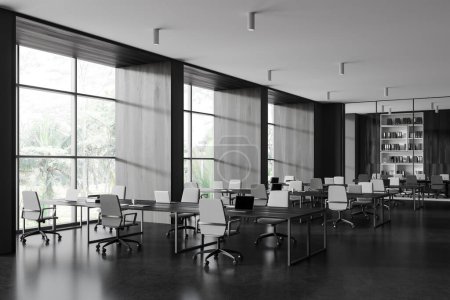 Foto de Corner view of office business interior with coworking and glass meeting room, armchairs on black concrete floor. Panoramic window on tropics. 3D rendering - Imagen libre de derechos
