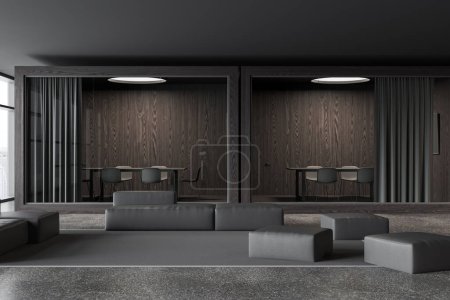 Téléchargez les photos : Dark office interior with relaxing and glass meeting boxes in row, modular sofa pouf on carpet, grey granite floor. Panoramic window on city skyscrapers. 3D rendering - en image libre de droit