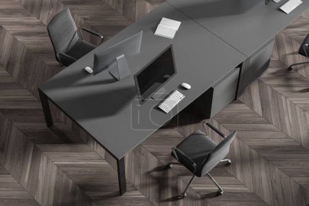 Photo for Top view of coworking interior with pc computers on desk, grey armchairs on hardwood floor. Modern office workplace with minimalist furniture for teamwork. 3D rendering - Royalty Free Image