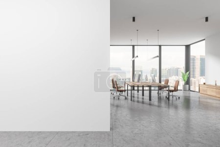 Téléchargez les photos : White business interior with pc monitors on desk, sideboard on light tile concrete floor. Coworking room with panoramic window on Kuala Lumpur. Mockup blank empty partition. 3D rendering - en image libre de droit